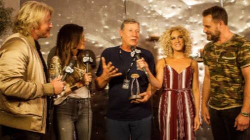 HONOUR: Rob Potts (centre) receives the award from Little Big Town.