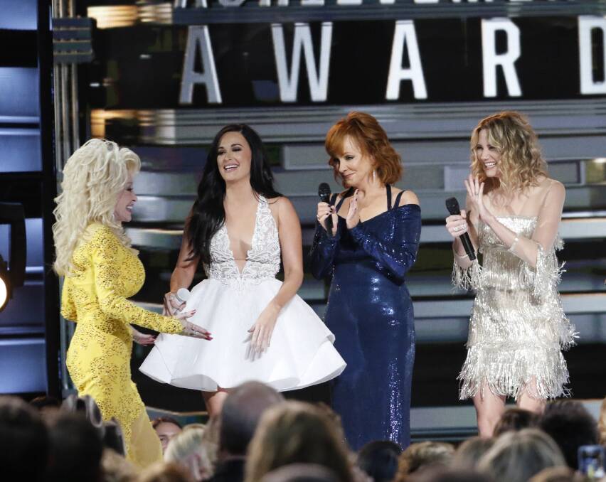 ON SONG: Dolly Parton was honored with the Willie Nelson Lifetime Achievement Award following a tribute by (from left) Kacey Musgraves, Reba McEntire and Jennifer Nettles who sang a medley of her songs.