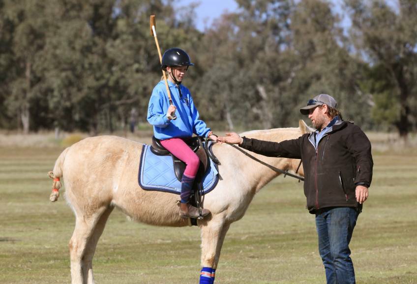 YOUTH DRIVE: Charlotte Craig, riding Sophie, receives tuition from former Australian polo captain Andrew Williams at a Gunnedah Polo Club clinic this month. Photo: Elesa Art Studios