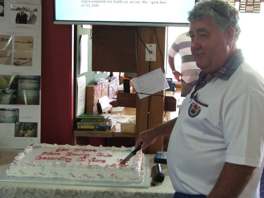 MILESTONE: Glen Innes men's bowls president Ian Pringle cutting the cake when the club celebrated 100 years.