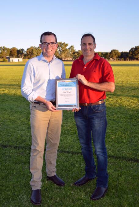 Adam Marshall presents Peter Oliver with his award for volunteering.