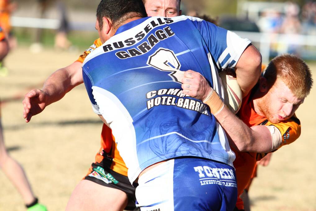 GUTSY: Uralla halfback Kearin Stiff puts his decidedly smaller body on the line in tackling Barraba prop Tim Coombes in a Second Division clash this year. Photo: Mark Bode