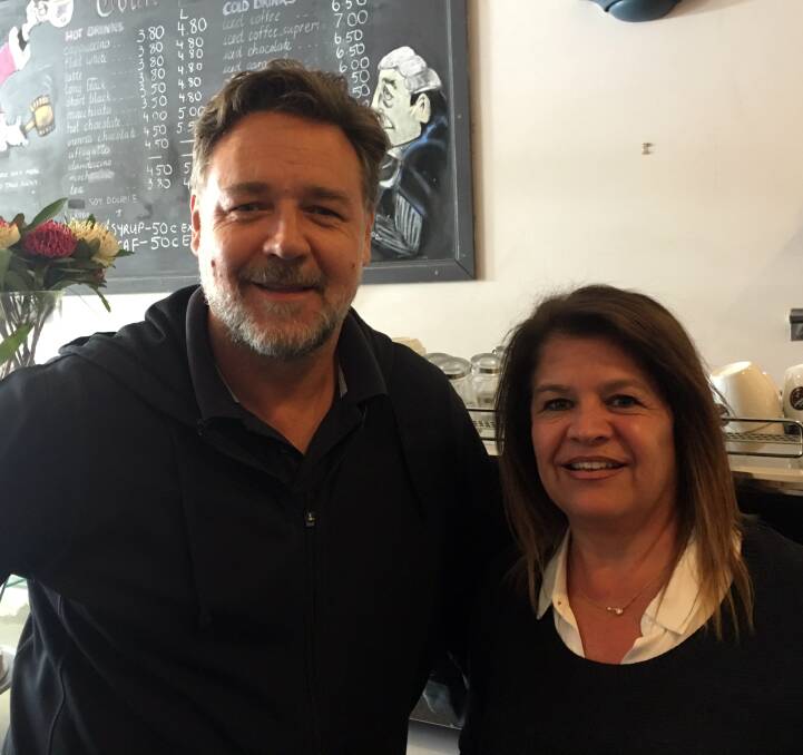 CELEBRITY CUSTOMER: Hollywood star Russell Crowe, left, stops in to the Courthouse Coffee Shop for a photo with co-owner Chrissy Rologas during a visit in Armidale this week. Photo: Supplied