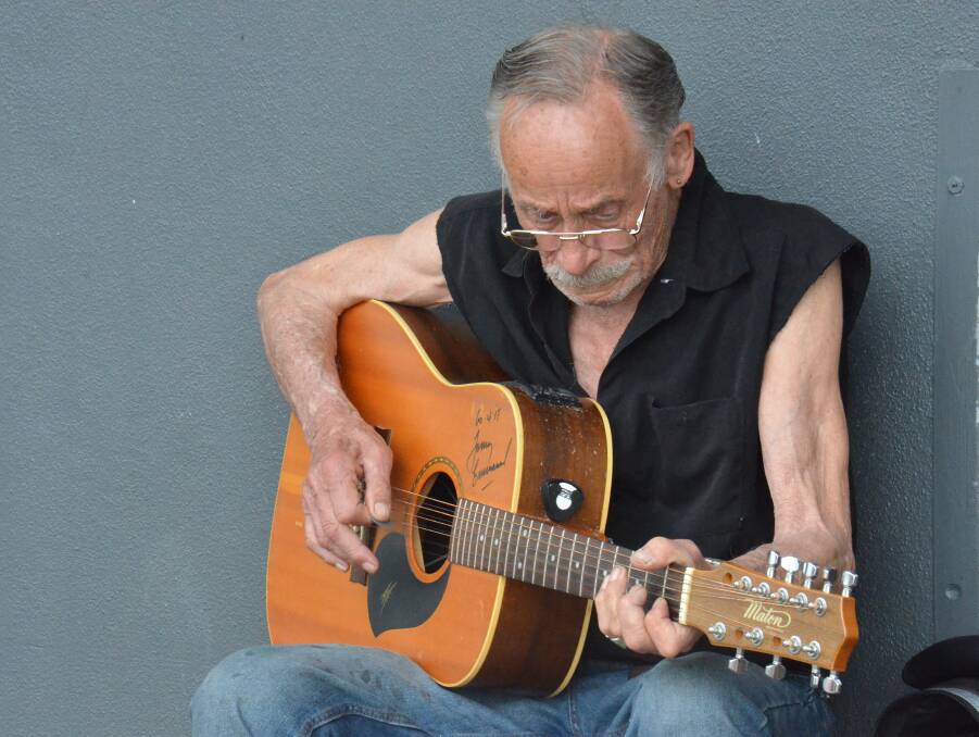 MAN BEHIND THE MUSIC: At almost 80 years old, 'Sunshine' sits outside the Armidale's Coles shopping complex every afternoon to play songs from days gone by. Photo: Rachel Baxter.