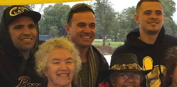 Star struck: Anthony Mundine (left) and Shannon Noll (centre) pose for a photo with fans during Gunnedah's Concert by the River on Wednesday afternoon.