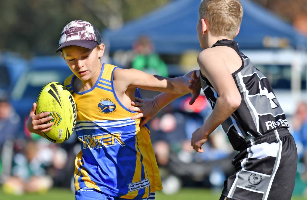 IN ACTION: Hunter's Sam Mitchell takes the touch from Riverina's Jake Scott as Tamworth  hosts PSSA Touch Championships. Photo: Barry Smith 260716BSB24
