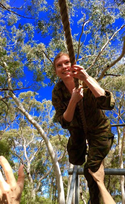 NEW HEIGHTS: Tamworth lawyer Fiona Burns tackles a high-ropes obstacle during a two-day army training course. Photo: Contributed