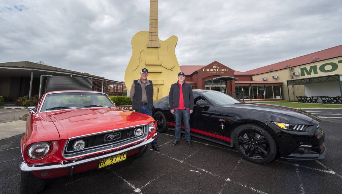 BOYS AND THEIR TOYS: Neville Evans with his 1968 Mustang and Steve Bartlett with his 2016 Mustang Photo: Peter Hardin 180916PHB005