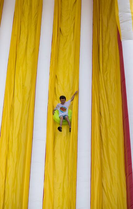 TIME OF HIS LIFE: This local was one of many testing out the slide, standing 15m high and 85m long, during the obstacle course. Photo: Peter Hardin 170916PHE067