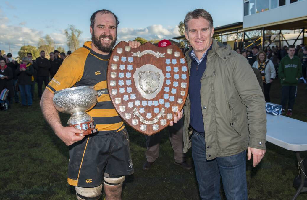 TOP PERFORMANCE: Pirates skipper Conrad Starr won player of the grand final on Sunday. He is pictured with Tim Horan. Photo: Peter Hardin 030916PHC369