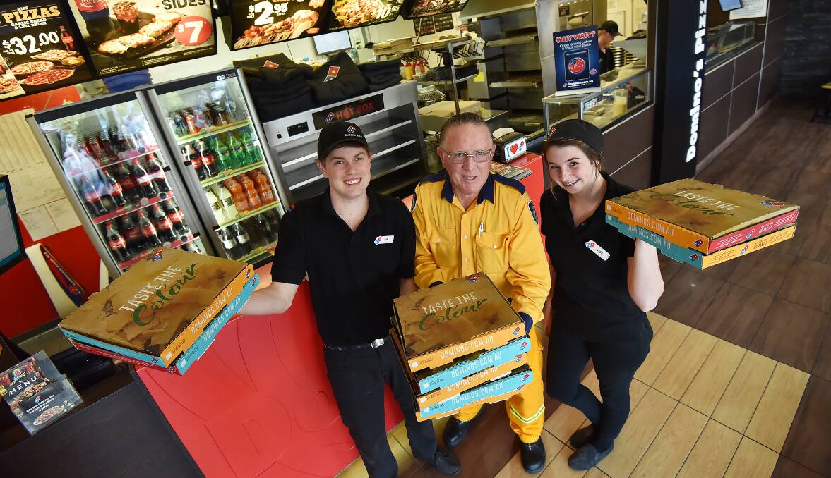 DOUGHRAISER: $1 sold from every pizza at Dominos today goes to the Tamworth Rural Fire Service. Pictured are Sam Holt, Phil Cole and Jess White. Photo: Gareth Gardner 210916GGC02