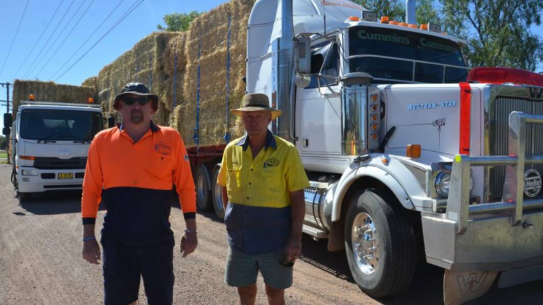 FIRE RELIEF: Gunnedah Shire Council's Michael Williams and Shaw's Transport's Kenton Shaw truck hay from "Kibah" to victims of the Sir Ivan fire.