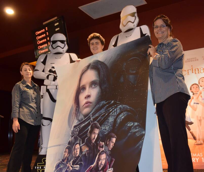 STAR WARS FANS: Tamworth Forum 6 Cinemas staff Sam Wood, Tyler James and Lisa Horner show off some Star Wars paraphernalia of the launch of Rogue One.
