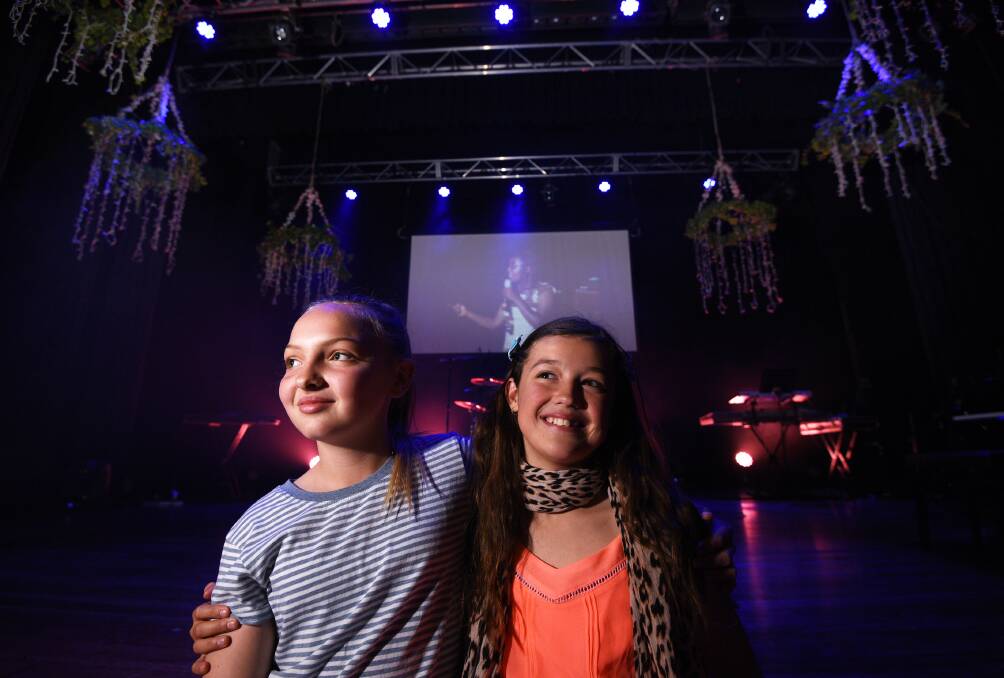 STRONG FORCE: Shine Conference.  Bailee Puls, 11, and Bianca Aylwin, 12, both of Tamworth, at the Shine conference at War Memorial Town Hall on Saturday.  Photo: Gareth Gardner 120817GG109