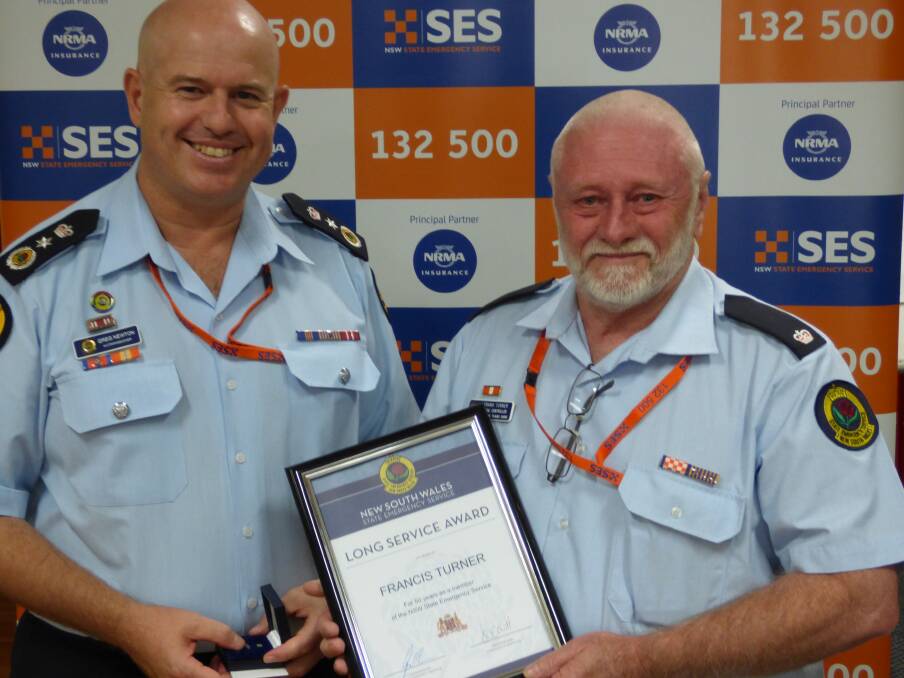 ACHIEVEMENT: NSW SES Acting Commissioner Greg Newton (left) presenting Liverpool Plains Local Controller Frank Turner (right) with his 50 year long service award in Inverell on Saturday.