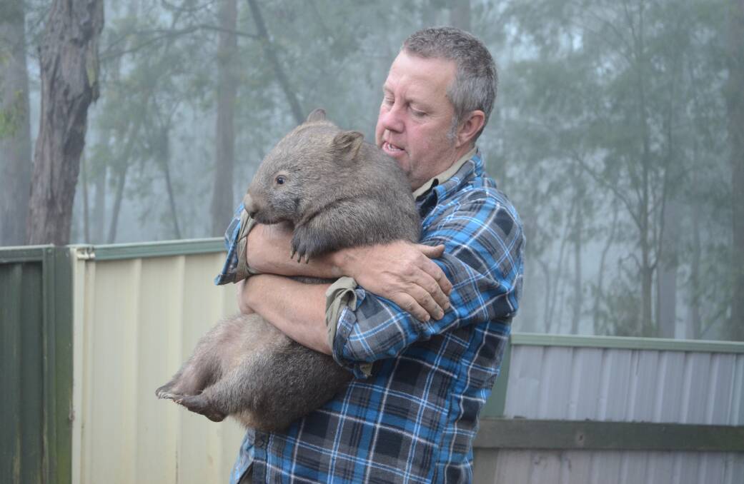 Kevin gives a furry friend a cuddle. Pictures Jessica Brown.