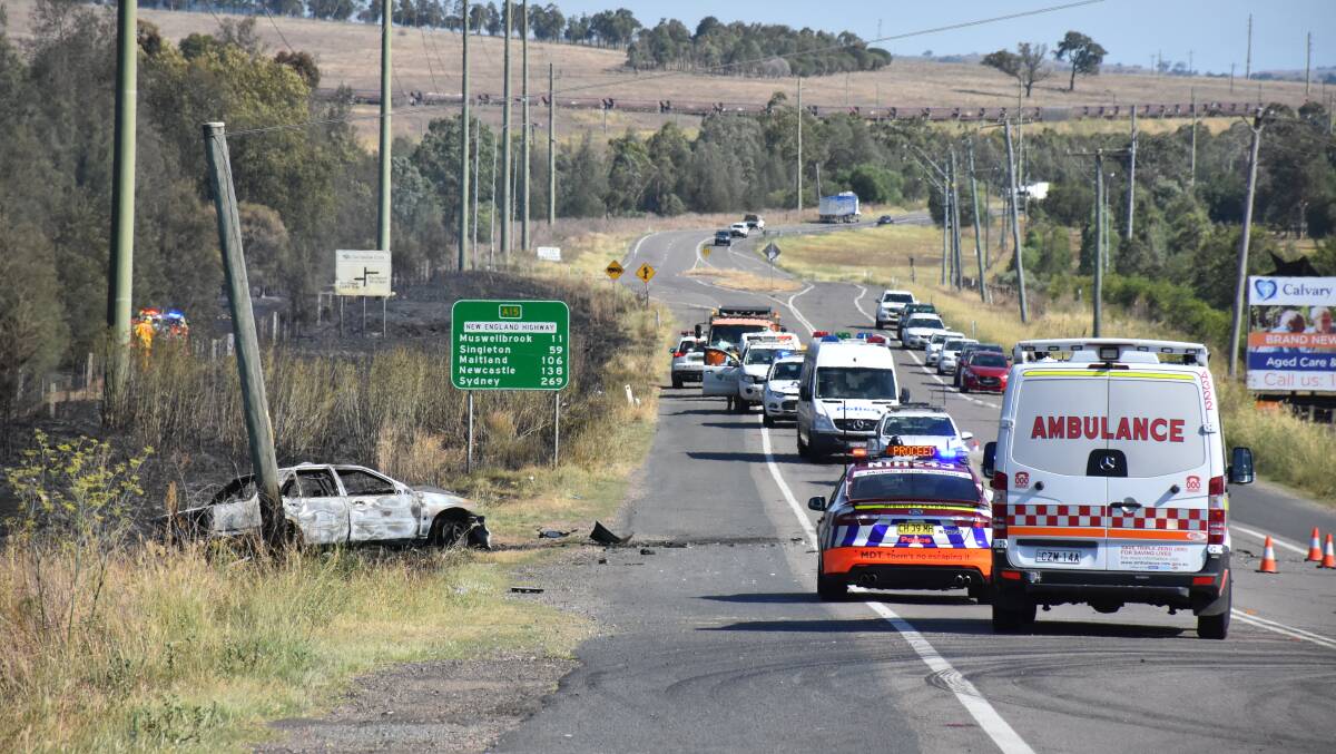 Crime scene: Police and emergency services at the crash site which killed one and seriously injured two others on the New England Highway at Aberdeen. Photo: Fairfax Media