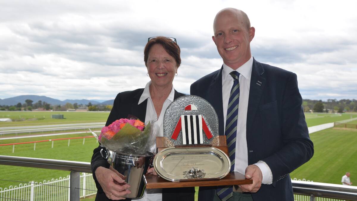 OUTSTANDING SERVICE: Former secretary-manager Helen Sinclair with Muswellbrook Race Club chairman John Sunderland at the Skellatar Park circuit on Friday.