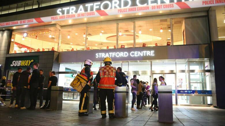 Emergency services personnel at Stratford Centre after the suspected acid attack.
Photo: AP