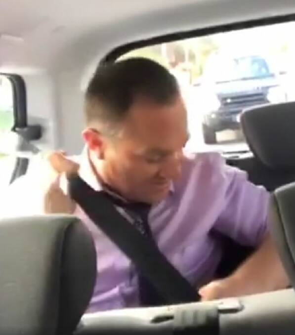 Former test player Michael Slater buckles up after someone watching the video notes he is not wearing a seatbelt. 