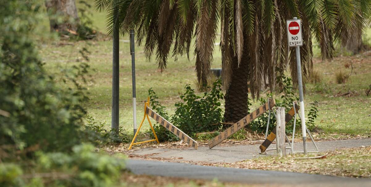 SHUTDOWN: Barricades close off a road within the Morisset Hospital grounds near where a crime scene was established after criminal psychiatric patient allegedly stabbed his flatmate in the neck.