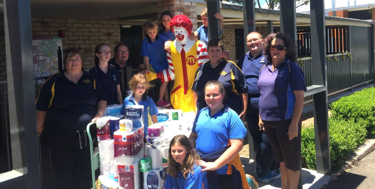 Giving back: The Girl Guides donated packets of toilet paper to Ronald McDonald House in late December.