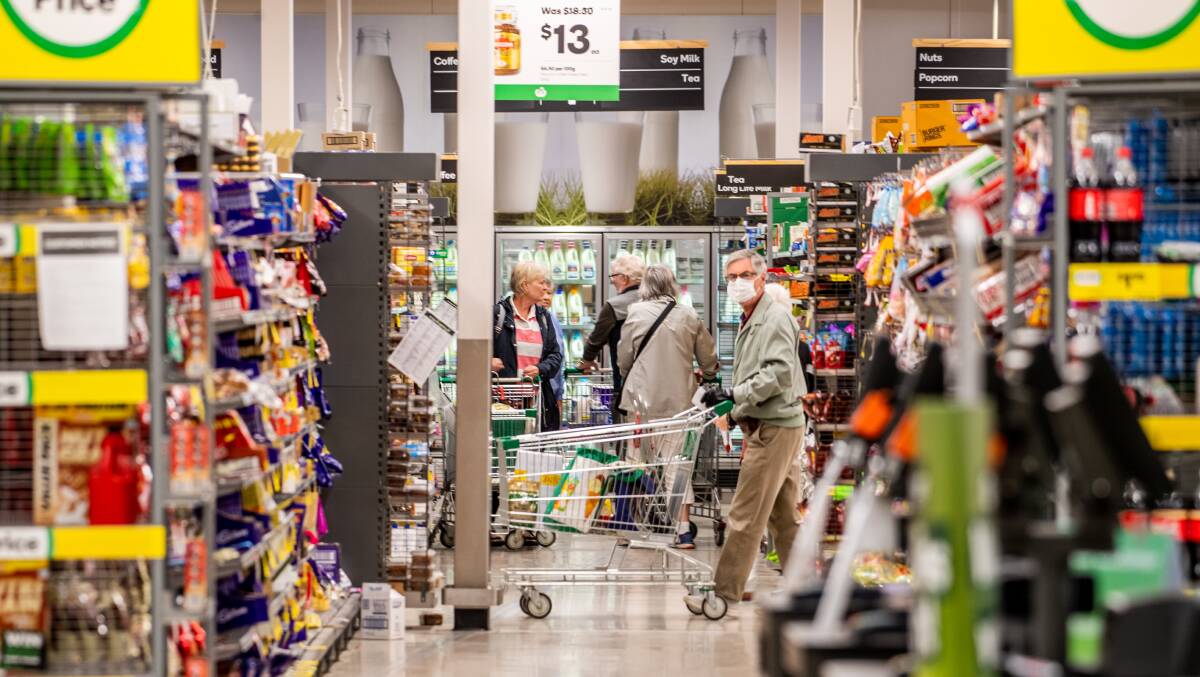 CURFEW TALK: Elderly shoppers made the most of a dedicated shopping hour at Woolworths, it was announced to give them the opportunity to collect necessary items. Picture: Karleen Minney, Canberra Times