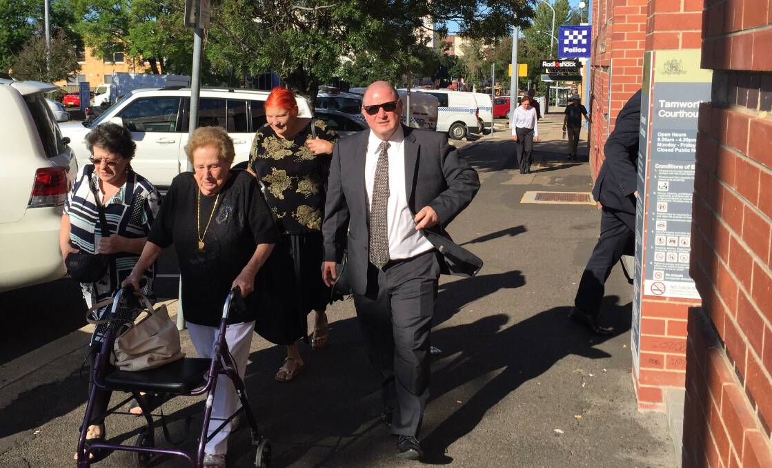 COURT: Tamworth licensee Michael Foxman outside Tamworth Local Court with his family on Thursday. Photo: Madeline Link