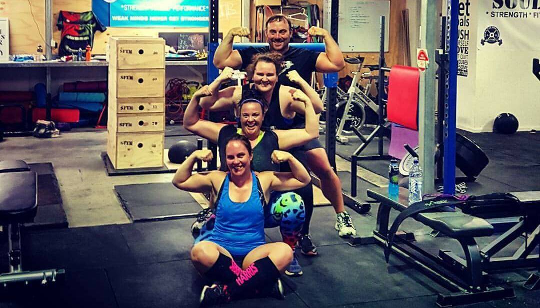 Hitting the streets: Trainer Jay Ramirez with Tamworth strongwoman trio Melissa O’Connell, Kat Mackie and Madii Corey as they prepare for the Tamworth tournament.