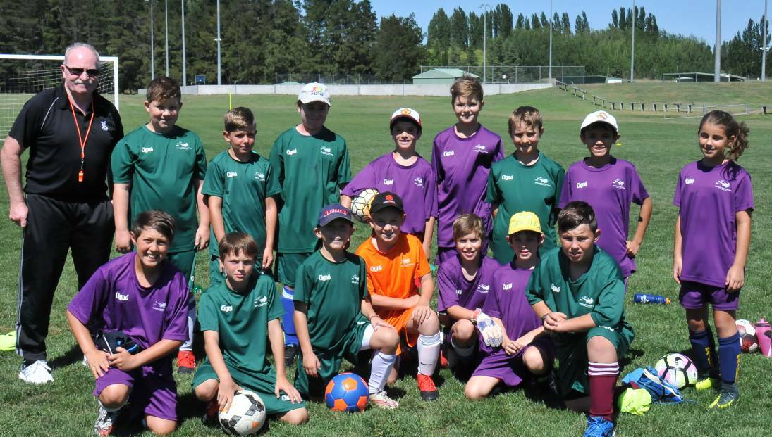 YOUNG TALENT: Brian McCarthy with under 10 and 11 players at the National Football Camp at SportUNE in Armidale. Picture: Ellen Dunger