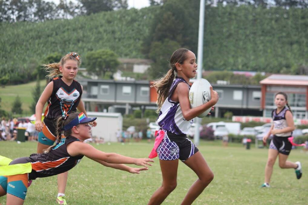 Out of reach: Tamworth's Kiana Duckett avoids the desperate reach of an opponent at the NSW Oztag Championships.