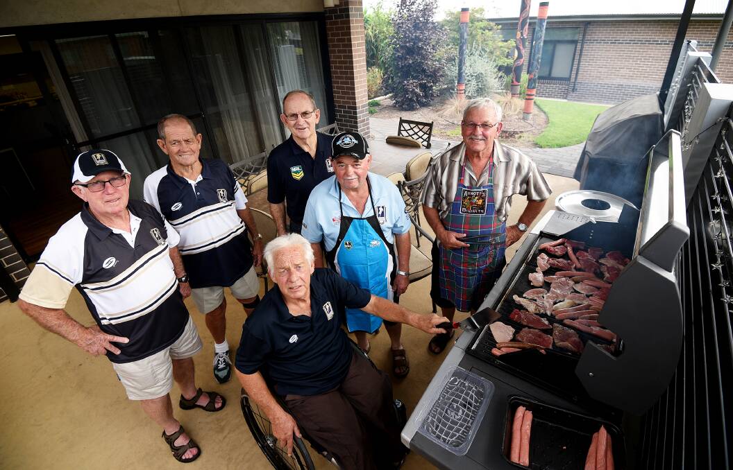 Cooking: Men of League identities (back row) Kevin Robinson, Bob Schier, Ken Thompson, (front row) Bob Claydon, Nugget Cooper, Peter Virgen at the barbecue.