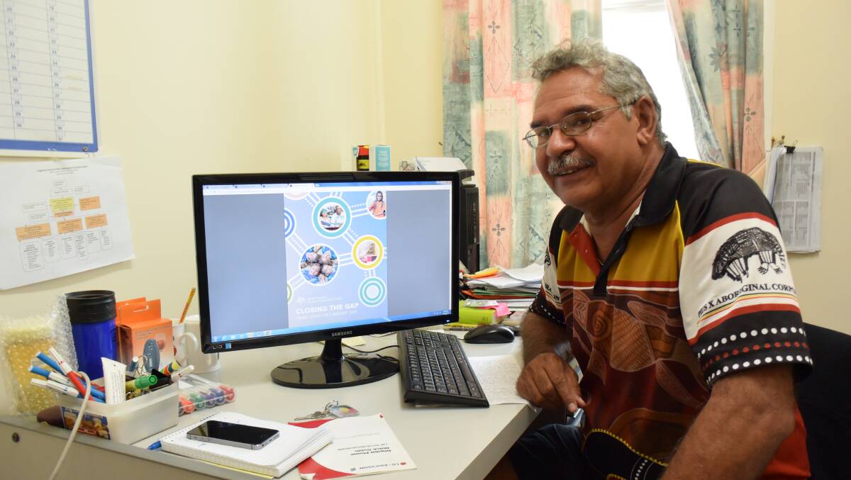 Report review: Pius X Aboriginal Corporation program officer Ray Dennison scrolls through the latest Close the Gap report in Moree on Tuesday.
