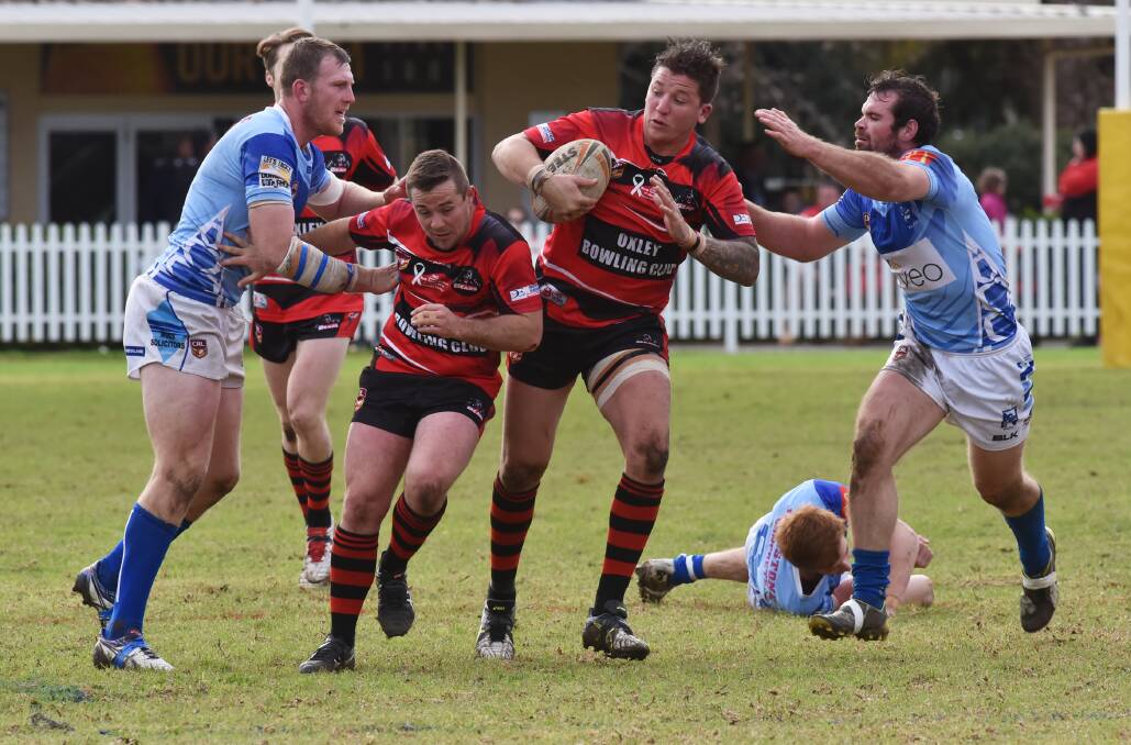 Move: Kieran Fisher gets evasive as Narrabri's Jake Rumsby and Lachlan Cameron converge on Bear Shane Wadwell. Photo: Geoff O'Neill