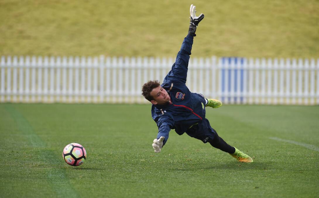 Off balance: Newcastle Jets keeper Pierce Clark is tested by this shot during Thursday's training session. Photo: Gareth Gardner 110816GGA05