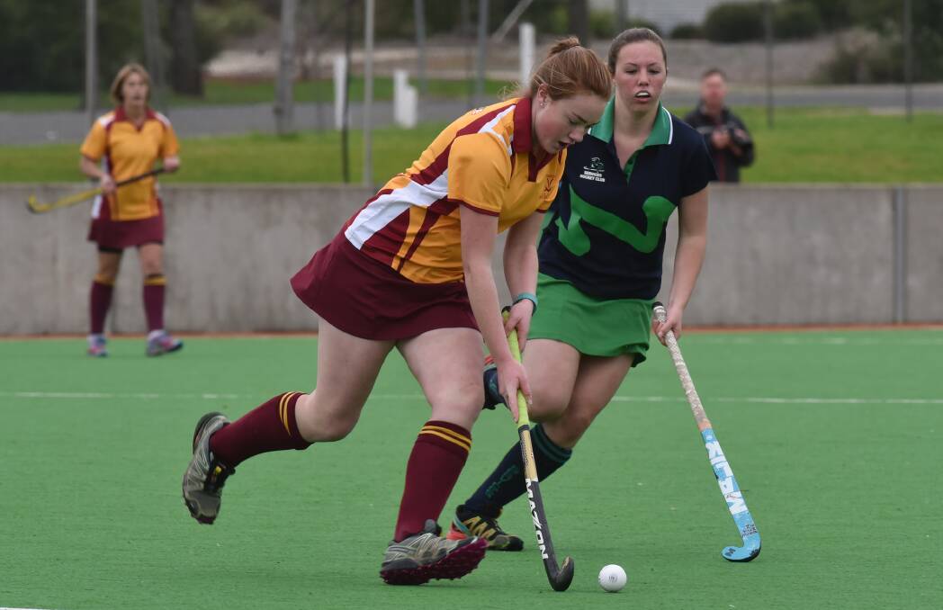 On the attack: Services' Abby Griffiths' shadows Tudor Wests' Sarah Willis on this run during their clash on Sunday. Photo: Geoff O'Neill 240716GOH07