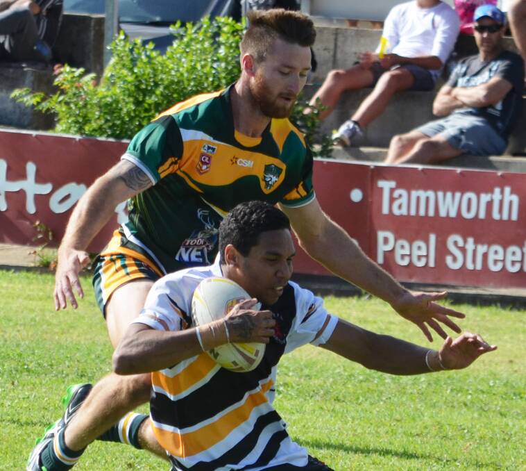 Grouping in: Singleton's Clinton Blenman tackles Inverell's Harold Duncan during this season's Greater Northern Championships in Tamworth.  Photo: Chris Bath 240416CBA 17.