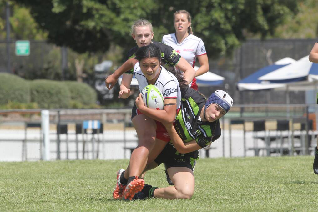 Rhiannon Byers drags this Griffith University player to the ground. Photo: ARU Media/Sportography. 