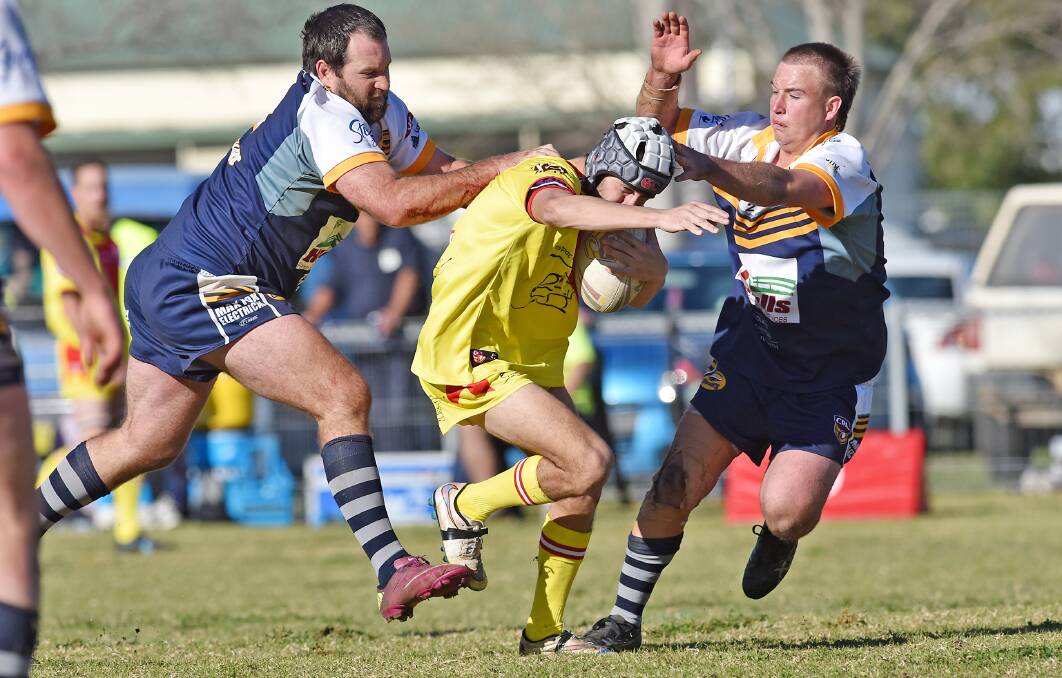 Clutch tackle: Dungowan's Shaun Ferguson (left) and Lochie Collins team up to drag down Kootingal's Cameron Venables. Photo: Gareth Gardner