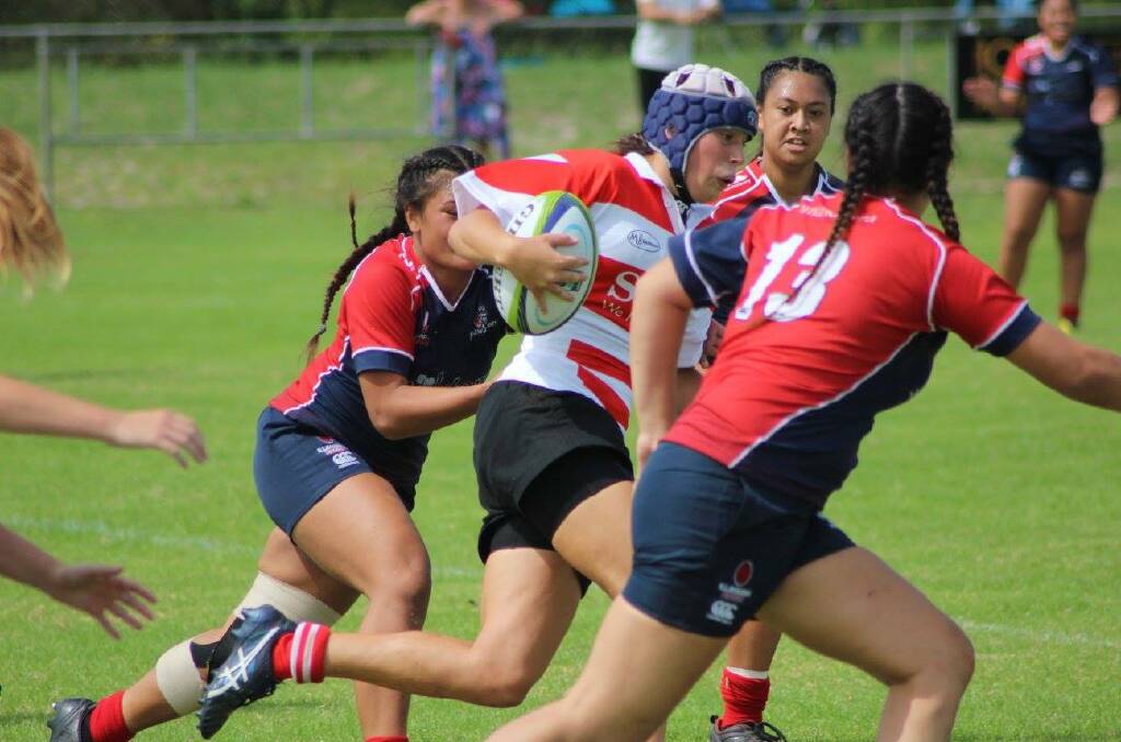 Strong run: Rhiannon Byers puts the foot down to try and squeeze through this hole playing for Central North against Illawarra on Saturday. Photo: Abbie Kent