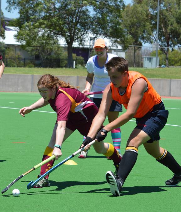 Sticking to it: The boys and girls squads did battle to conclude Sunday's training session. Here Sarah Willis and Andrew Cross compete for possession.