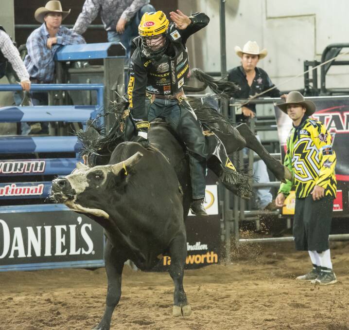 One hell of a ride: US cowboy Matt Triplett claimed his maiden win in Tamworth after riding all three of his bulls when the PBR bucked into Tamworth on Saturday night. Photo: Peter Hardin 121116PHD294
