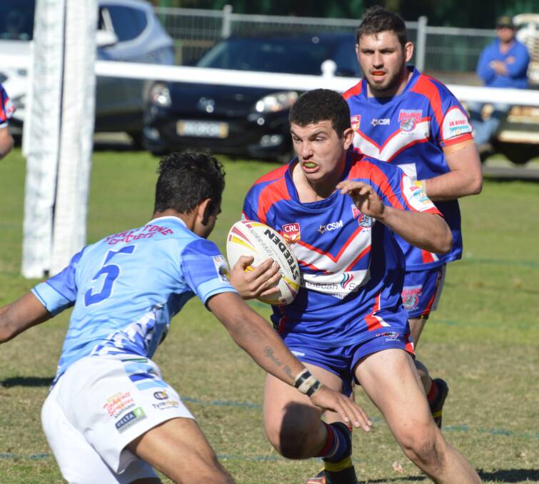 Stepping: Gunnedah centre Sam Lumby charges towards an awaiting Robert Condran, as Aaron Donnelly looms behind, during Saturday's minor semi-final.