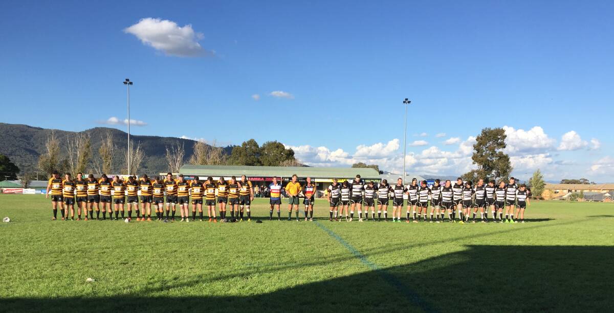 Player's observe a minute's silence before the first grade game.