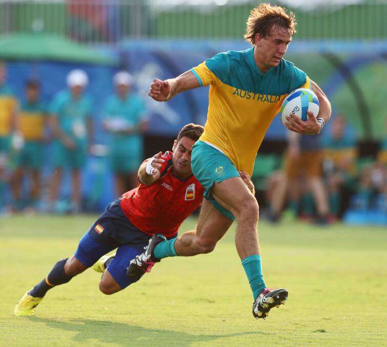 Leader: John Porch, pictured here trying to break through against Spain, will captain the Aussie mens sevens side in Fiji this weekend. Photo: David Rogers/Getty Images
