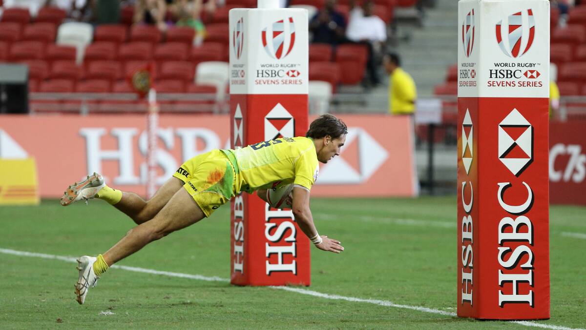 Try-time: John Porch scores the opening try of Australia's 40-7 semi-final loss to the USA at the Singapore Sevens on Sunday. Photo: Getty Images