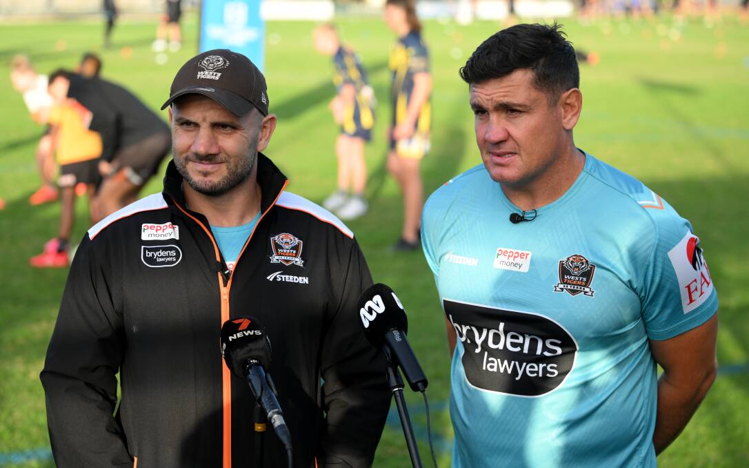Tigers assistant coaches Robbie Farah and Chris Heighington address the media.