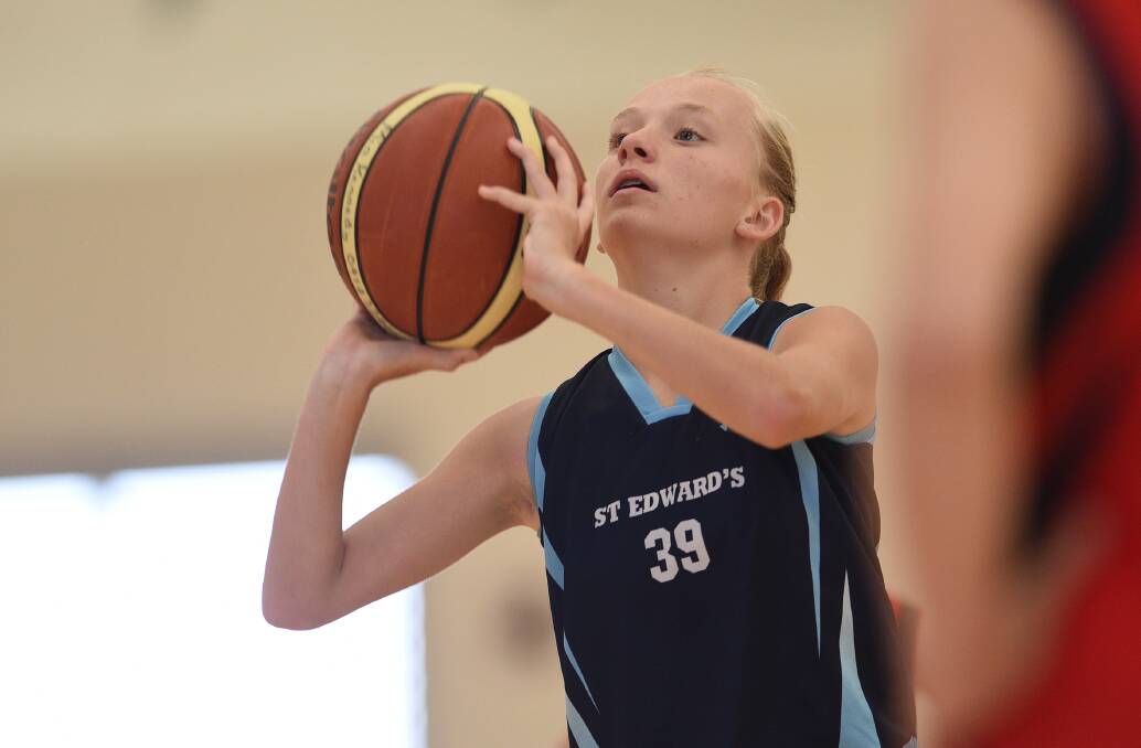 Concentration: St Eds Lynx's Zoe Richard lines up this shot during her side's win over the Timbumburi Taipans in the 5/6 Girls A grand final. Photo: Gareth Gardner 041216GGC09