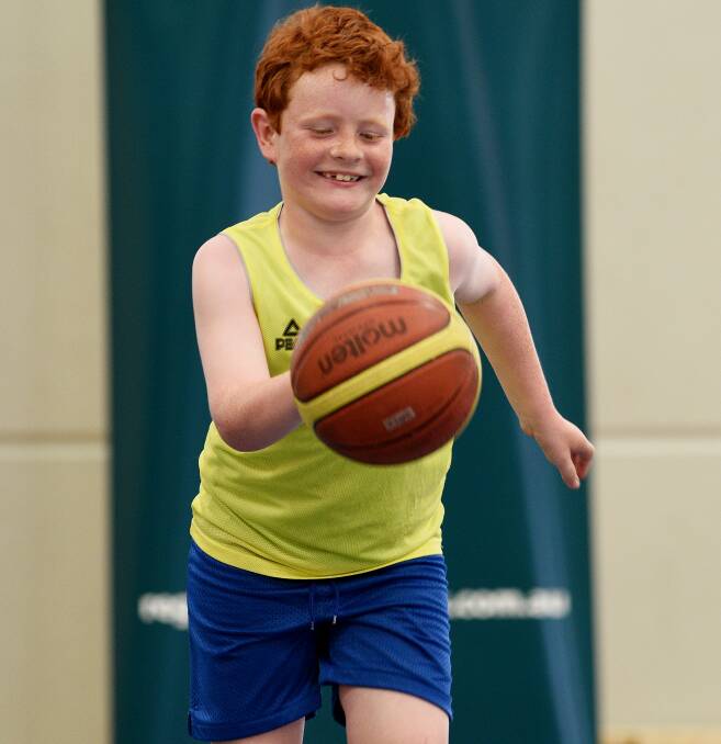 On the bounce: Charlie Cunningham is all smiles as he practices his dribbling skills. Photo: Gareth Gardner 011216GGG04
