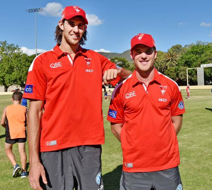 Spreading their wings: Sydney Swans Sam Naismith (left) and Tom Mitchell prepare to run an Auskick clinic during their visit to Tamworth earlier this year. 
